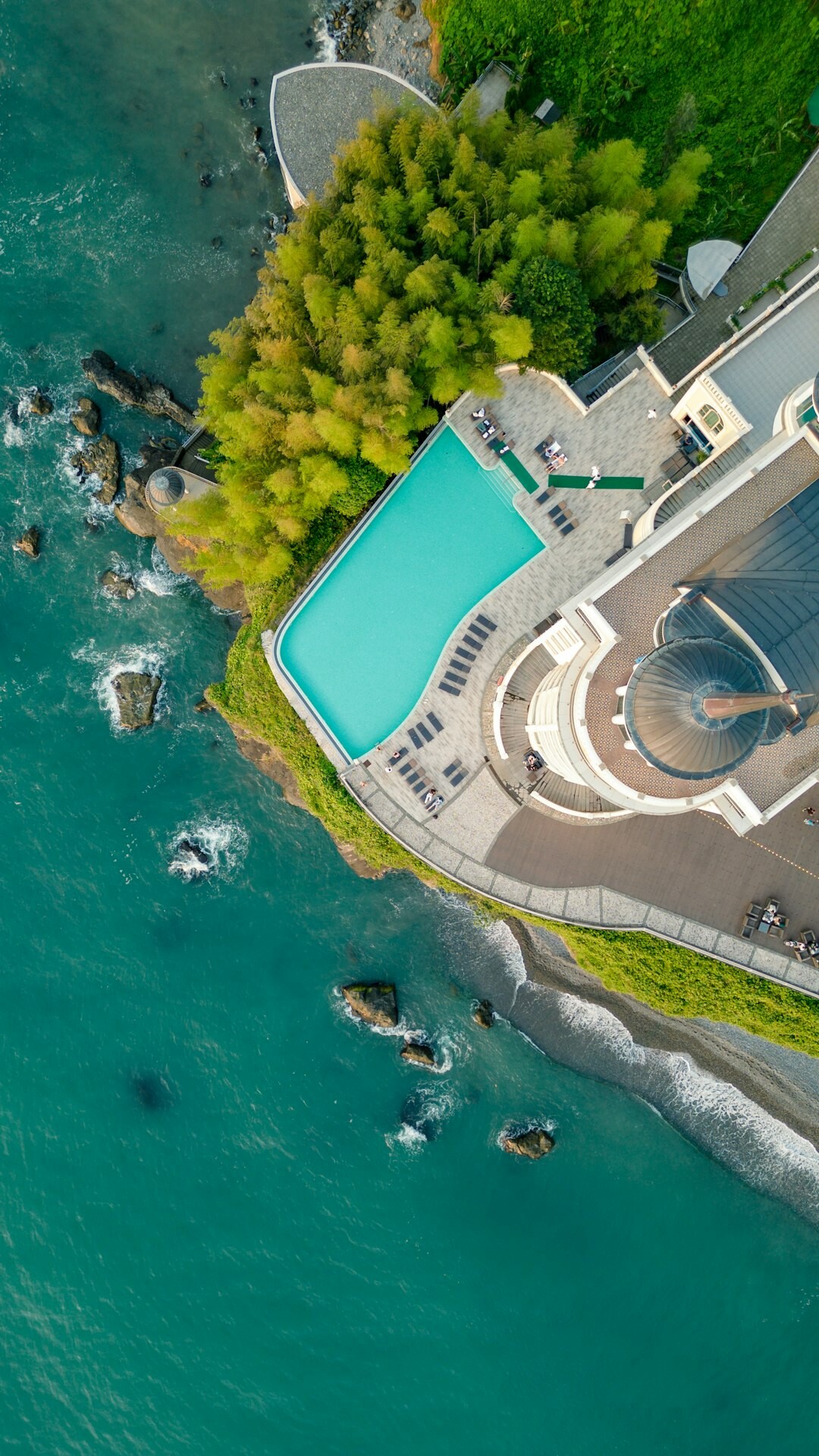 Modern oceanfront villa with infinity pool at sunset